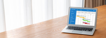 Project planning software for modish business project management on the computer screen showing timeline chart of the team projectの写真素材
