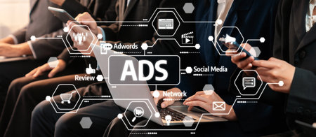 Digital marketing professionals collaborate in a modern office environment, showcasing technology trends and advertising strategies through laptops and smartphones. Amityの写真素材