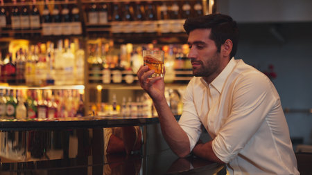 Smart man in white shirt drinking cocktail Old fashioned of special party beverage vibrant waiting...