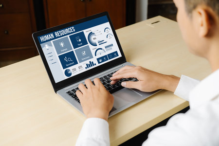 Human resources management software on computer screen helping human resources employee to manage...