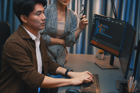 IT developers discussing with point to intelligent website development coder system running data online two screens information technology at neon light room at modern office. Infobahn.の写真素材