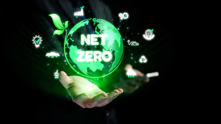 A pair of hands cradles a glowing green globe depicting the net zero concept, surrounded by symbols of sustainability and eco-friendliness, representing a greener future.の写真素材