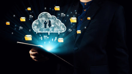 A professional person in a suit holds a tablet with visual elements of cloud storage, digital...