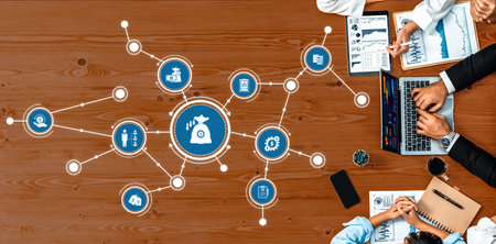 A top-down view of a collaborative business strategy session featuring financial icons and data...