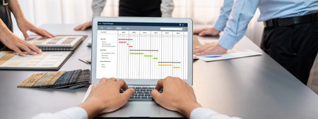 Group of interior architect designer team at table choosing various mood board samples with architecture software on laptop screen. Modern renovation and interior material selection concept. Insightの写真素材