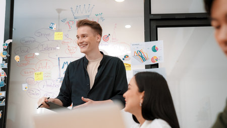 Professional male leader presents start up project by using mind map, colorful sticky notes and...