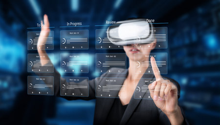A business professional engages with virtual reality technology to oversee project tasks and streamline planning processes, enhancing efficiency in the modern office.の写真素材