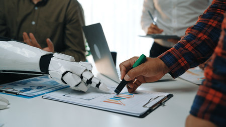 A human hand collaborates with a robotic arm, showcasing innovative teamwork in a business meeting....
