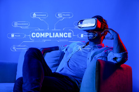 A man sits comfortably with a virtual reality headset, engaged in exploring compliance regulations and governance policies in a futuristic business setting, highlighting innovation. XDMCPの写真素材