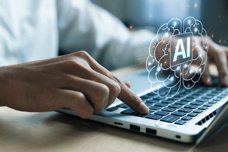 A close-up view of hands typing on a laptop, featuring a graphic of a brain symbolizing artificial...