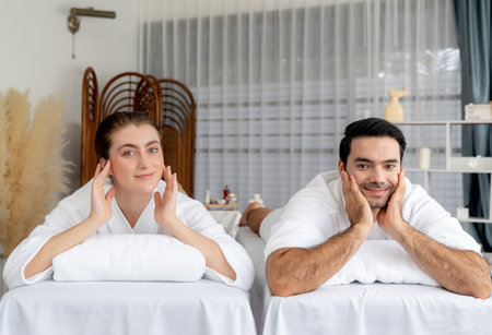 Caucasian couple customer enjoying relaxing anti-stress spa massage and pampering with beauty skin recreation leisure in day light ambient salon spa at luxury resort or hotel. Quiescentの写真素材