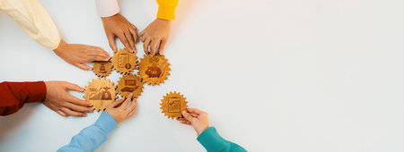 A group of hands from diverse individuals hold wooden badges symbolizing business achievements. This image captures the essence of teamwork and strategic growth in the professional environment. Amityの写真素材