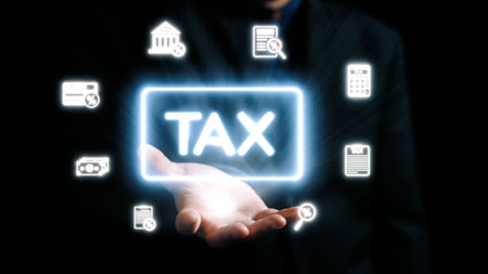 A professional hand showcases a glowing tax symbol surrounded by digital icons representing various financial services, emphasizing modern tax management and consultation approaches.の写真素材