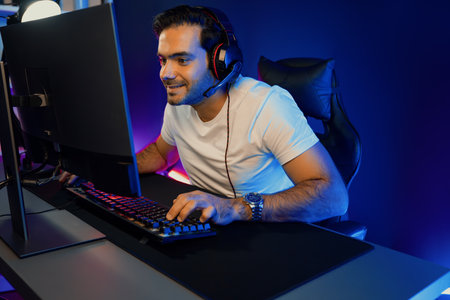 Serious face gaming streamer concentrating gaming players trying to pass at mission completed, using...