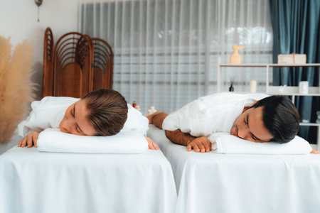 Caucasian couple customer enjoying relaxing anti-stress spa massage and pampering with beauty skin recreation leisure in day light ambient salon spa at luxury resort or hotel. Quiescentの写真素材