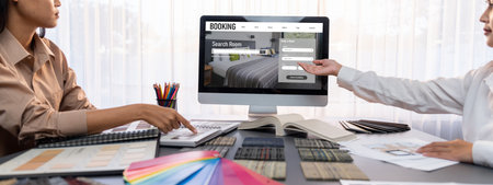 Group of interior architect designer team at table choosing various mood board samples with architecture software on laptop screen. Modern renovation and interior material selection concept. Insightの写真素材