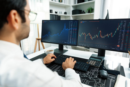 Smart trader businessman analyzing in two dynamic stock exchange investment screen on pc with...