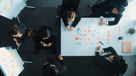 Top down aerial view of professional business team present project and turn around to clap hands and applause to celebrate successful project or financial growth in data analysis graph. Directorate.の写真素材