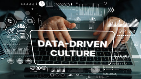 Hands Typing on Laptop Surrounded by Graphs and Icons Illustrating Data-Driven Culture in Modern Business Environment. Asymptotic smart data analytic.の写真素材