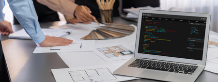 Group of interior architect designer discussing together on blueprint and laptop screen display architecture software for more precise designing layout. Modern home design and renovation. Insightの写真素材