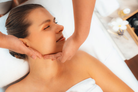 Panorama top view of woman enjoying relaxing anti-stress head massage and pampering facial beauty skin recreation leisure in dayspa modern light ambient at luxury resort or hotel spa salon. Quiescentの写真素材