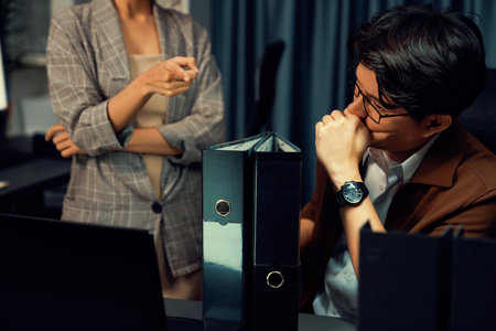 Managers discussing on document paperwork together for business planning on market share data at over late night time at modern home office, working on startup company deadline project job. Infobahn.の写真素材