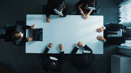 Top down aerial view of professional business team wear vr headset to enter virtual world while sitting and using hand gestures to manipulate the data from the manager laptop. Time lapse. Directorate.の写真素材