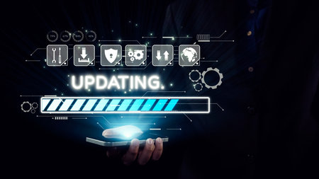 A visual representation of a smartphone showing an updating progress bar with various technology icons in the background, symbolizing digital enhancement and connectivity.の写真素材