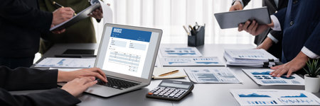 Panorama shot analyst team utilizing BI Fintech to analyze financial report with laptop. Businesspeople analyzing BI data dashboard displayed on laptop screen for business insight. Prodigyの写真素材