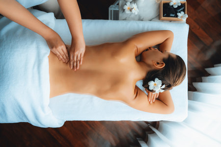 Panorama top view woman customer enjoying relaxing anti-stress spa massage and pampering with beauty skin recreation leisure in day light ambient salon spa at luxury resort or hotel. Quiescentの写真素材