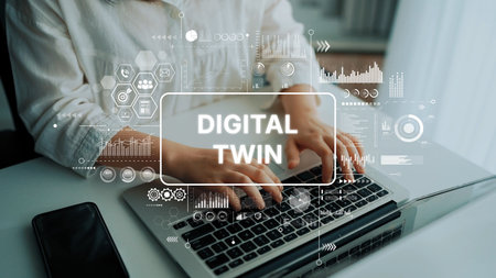 Hands Typing on Laptop with Overlay Graphics Representing Digital Twin Concept and Data Visualization Elements. Asymptotic smart data analytic.の写真素材