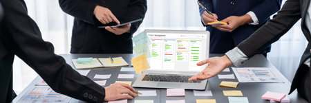 Analyst team use sticky note for creative and analytic brainstorm for business idea with BI data dashboard on laptop screen. Analysis financial data visualization tech for marketing strategy.の写真素材