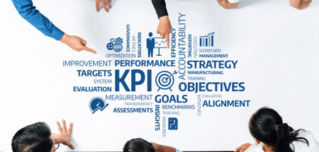 A top-down view of a collaborative workspace showcasing KPI visualization, strategic planning, and performance measurement with diverse team engagement and goal-oriented discussion. Amityの写真素材