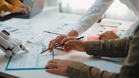 A dynamic business meeting featuring teamwork and collaboration focused on data analysis and project planning in a modern office setting.Noogenesisの写真素材