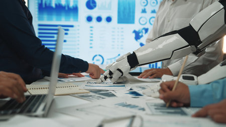A dynamic scene capturing the collaboration between humans and a robot in a modern office, showcasing technologys role in data analysis and teamwork synergy.Noogenesisの写真素材