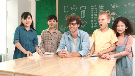 Professional caucasian teacher and diverse student looking at camera while happy school boy smiling....