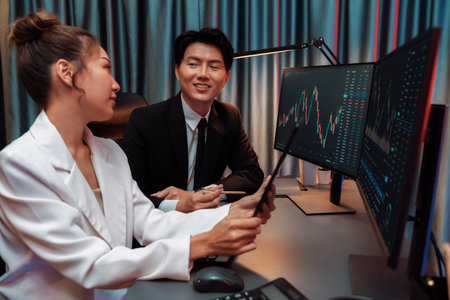 Businesswoman holding tablet on dynamic stock exchange statistic online showing to partners to...
