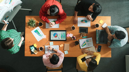 Top view of investor looking executive manager standing and presenting plan. Attractive businesswoman standing whiteboard and holding tablet display financial graph at business meeting. Convocation.の写真素材