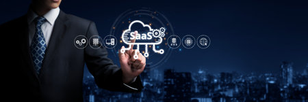 A businessman uses his finger to interact with a digital representation of a SaaS platform, highlighting cloud solutions and innovation in the tech industry.の写真素材