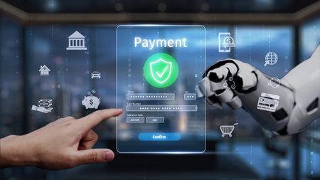A futuristic digital payment interface displays a human hand interacting with a robotic arm, highlighting the integration of technology and finance in contemporary business environments. Auvanaの写真素材