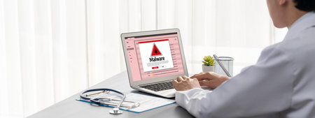 Cyber attacking concept. Malware alert showing on computer screen display scam and threat detection on computer system or online server to be removed brisk.の写真素材