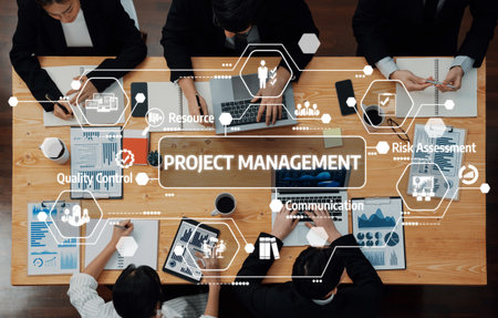 A bird-eye view of a team engaged in project management, highlighting collaboration, planning, and data-driven decisions in a contemporary office setting.の写真素材