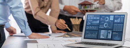 Group of interior architect designer discussing together on blueprint and laptop screen display architecture software for more precise designing layout. Modern home design and renovation. Insightの写真素材