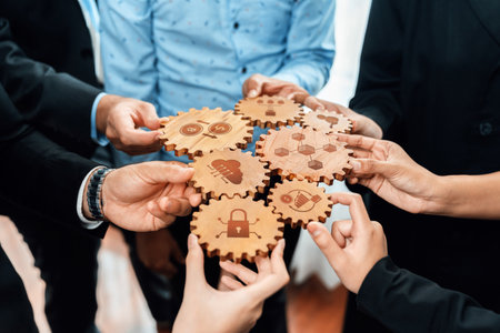 A diverse group of professionals collaborates using wooden gears, symbolizing teamwork and strategic...