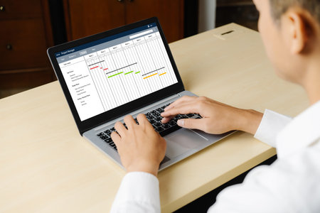 Project planning software for modish business project management on the computer screen showing timeline chart of the team projectの写真素材