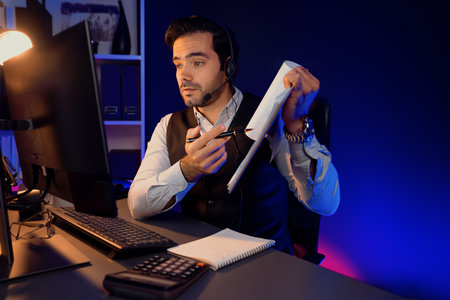 Smart businessman wearing headphones, remote meeting paperwork report folder online on pc, analyzing sales channel on product service compare market target customer at neon dark light room. Surmise.の写真素材
