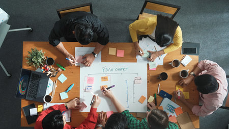 Top down aerial view of professional business people hands making scrum task board to manage...