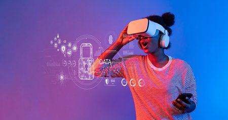 A young woman wearing a virtual reality headset interacts with digital security graphics, showcasing the exciting intersection of technology and user experience in a vibrant setting.の写真素材