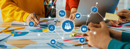 Groups of individuals engage in a collaborative design process, using digital tools and stationery...