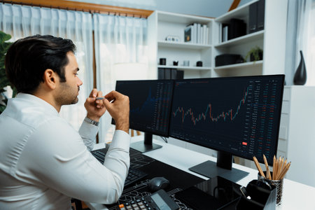 Smart trader businessman analyzing in two dynamic stock exchange investment screen on pc with investing highest profitable financial technology in searching market at modern home office. Surmise.の写真素材